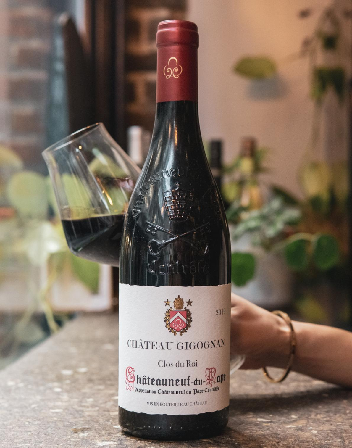 Château Gigognan Clos du Roi 2019 bottle with a glass of wine